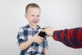Dad tries to take the child`s phone, on which he plays for a long time. The guy does not give up his smartphone and behaves