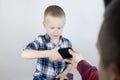 Dad tries to take the child`s phone, on which he plays for a long time. The guy does not give up his smartphone and behaves