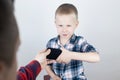 Dad tries to take the child`s phone, on which he plays for a long time. The guy does not give up his smartphone and behaves