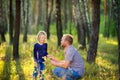 Dad walks in the park with his beloved daughter at sunset, holds his hand Royalty Free Stock Photo