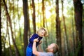 Dad walks in the park with his beloved daughter at sunset, throws up on his hands Royalty Free Stock Photo