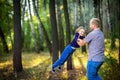 Dad walks in the park with his beloved daughter at sunset, throws up on his hands Royalty Free Stock Photo