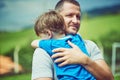 Dad will always be there to pick you up. Shot of a cheerful middle aged man holding his little boy in his arms outside Royalty Free Stock Photo