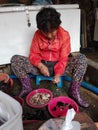 A woman cleans seafood at a fish stall in Dadaepo Fisherman`s Port, Busan