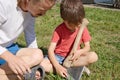 Daddy breeding boy in ax sharpening Royalty Free Stock Photo