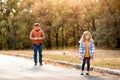 Daddy daughter play with machine on remote control in autumn Park