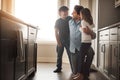 Daddy and his darlings. a happy father bonding with his two young children in the kitchen at home.