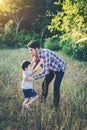 Daddy hugging her little boy. Family walking in the field. Outdo Royalty Free Stock Photo
