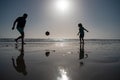 Daddy with kid boy playing on a summer day. Father and son play soccer or football on the beach on summer family Royalty Free Stock Photo