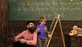 Daddy and kid laughing while learning new things. Smiling teacher and schoolboy having fun together Happy kid at school Royalty Free Stock Photo