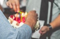 Daddy lighting birthday candles on birthday cake for children brithday party