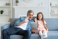 Daddy with little girl playing with tablet. Royalty Free Stock Photo