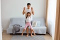 Daddy plays with his daughter, happy female kid yelling happily, family is having fun at home, happy healthy childhood, handsome Royalty Free Stock Photo