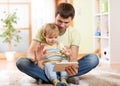 Daddy and son kid playing with tablet computer Royalty Free Stock Photo