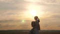 Daddy walks with his daughter on his shoulders in rays of sunset. Father and kid play. Happy family resting in park. Dad Royalty Free Stock Photo