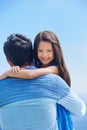 Daddys girl. Portrait of a little girl hugging her father and smiling over his shoulder at the camera. Royalty Free Stock Photo