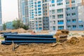 Large PVC pipes stacked next to wooden pallets at construction site in Sintanjin Dong Royalty Free Stock Photo