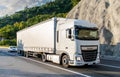 DAF, a large, white truck, a freight carrier, on a mountain road, on a summer day