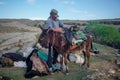 Dagestan, Russia - June 2, 2020: Shepherd and donkey with provisions