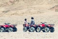 Dahab, Egypt May 11, 2019: Egyptian boys sit on ATVs in the desert Royalty Free Stock Photo