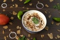 Dahi vada or bhalla is a type of chaat. Dahi bhalla bowl on textured background.