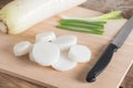Daikon radish on the wood cutting board. Selective focus. Royalty Free Stock Photo