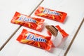 Daim milk chocolate and caramel candy on a wooden table.