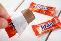 Daim milk chocolate and caramel candy on a wooden table