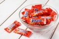 Daim milk chocolate and caramel candy on a wooden table.