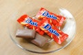 Daim milk chocolate and caramel candy on a wooden table.