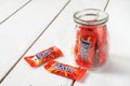 Daim milk chocolate and caramel candy on a wooden table.