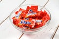 Daim milk chocolate and caramel candy on a wooden table.