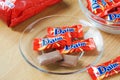 Daim milk chocolate and caramel candy on a wooden table.