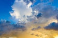 Dainty wispy pale salmon pink and golden yellow clouds at sunset and raining