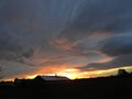 Dairy barn cupolas silhouetted by sunset Royalty Free Stock Photo