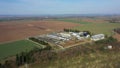 Cowshed fields farm intensive field dairy cows feeding barn drone aerial video shot, large agricultural activity Royalty Free Stock Photo