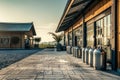 Dairy farm yard in the early evening, tin cans for milk Royalty Free Stock Photo