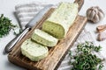 Dairy green butter with herbs, on white stone  background Royalty Free Stock Photo