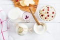 Dairy produce. Milk in bottle, cottage cheese in bowl, kefir in jar, cranberry yogurt in glass, butter and fresh berries