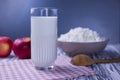 Dairy product cottage cheese in a plate with a glass of milk and apples Royalty Free Stock Photo