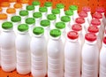 Dairy products bottles with bright covers on a shelf in the shop