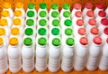 Dairy products bottles with bright covers on a shelf in the shop