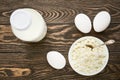 Dairy products, milk, cottage cheese and eggs on a dark wooden table, top view Royalty Free Stock Photo