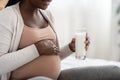 Dairy Products During Pregnancy. Black Pregnant Woman Holding Glass With Milk, Closeup