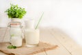 Dairy starter culture for the preparation of fermented milk products in a glass on a white wooden background with a copy space