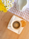 Daisies and dandelions, a cup of coffee and a cookie on a wooden table Royalty Free Stock Photo