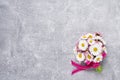 Daisy bouquet on gray concrete background. Copy space, top view.