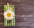 Daisy flower fork knife  wooden background Royalty Free Stock Photo