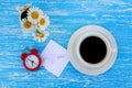 Daisy flowers, alarm clock and cup of coffee with I love you note Royalty Free Stock Photo