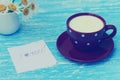 Daisy flowers and cup of milk with I love you note Royalty Free Stock Photo